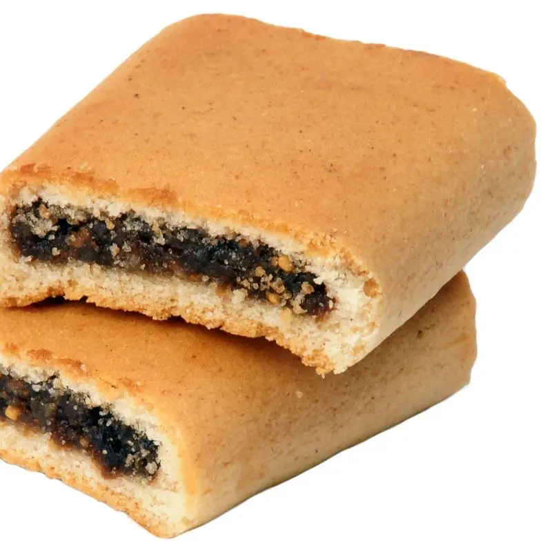 Dos galletas rellenas de pasta de higo apiladas sobre fondo blanco