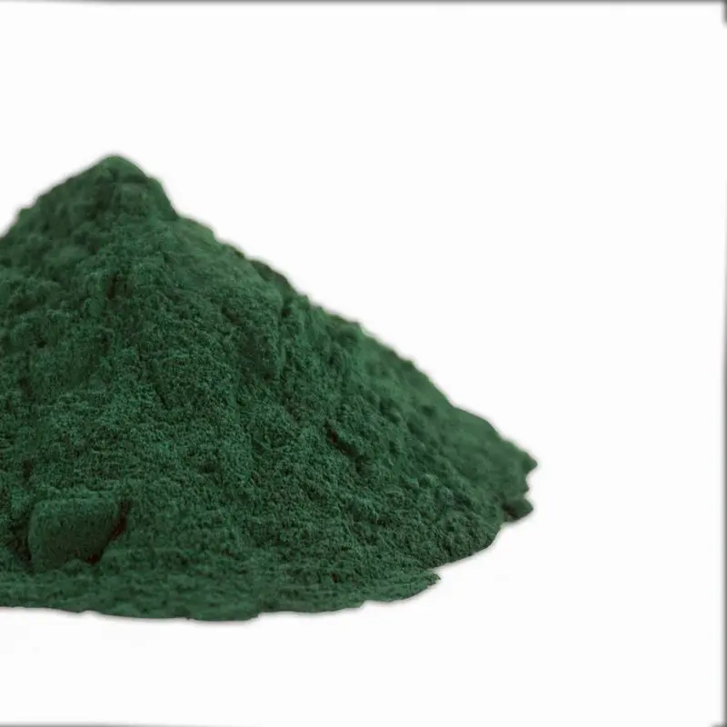 Montículo de espirulina en polvo de color verde oscuro sobre fondo blanco
