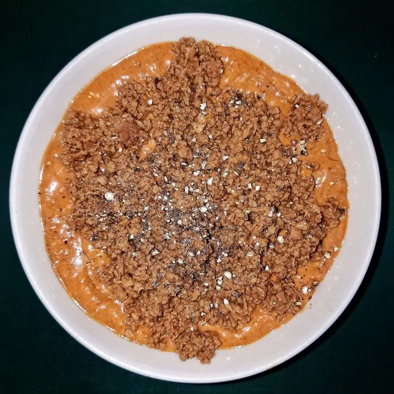 Cuenco de salsa de tomate cubierta de proteína de soja texturizada desmenuzada