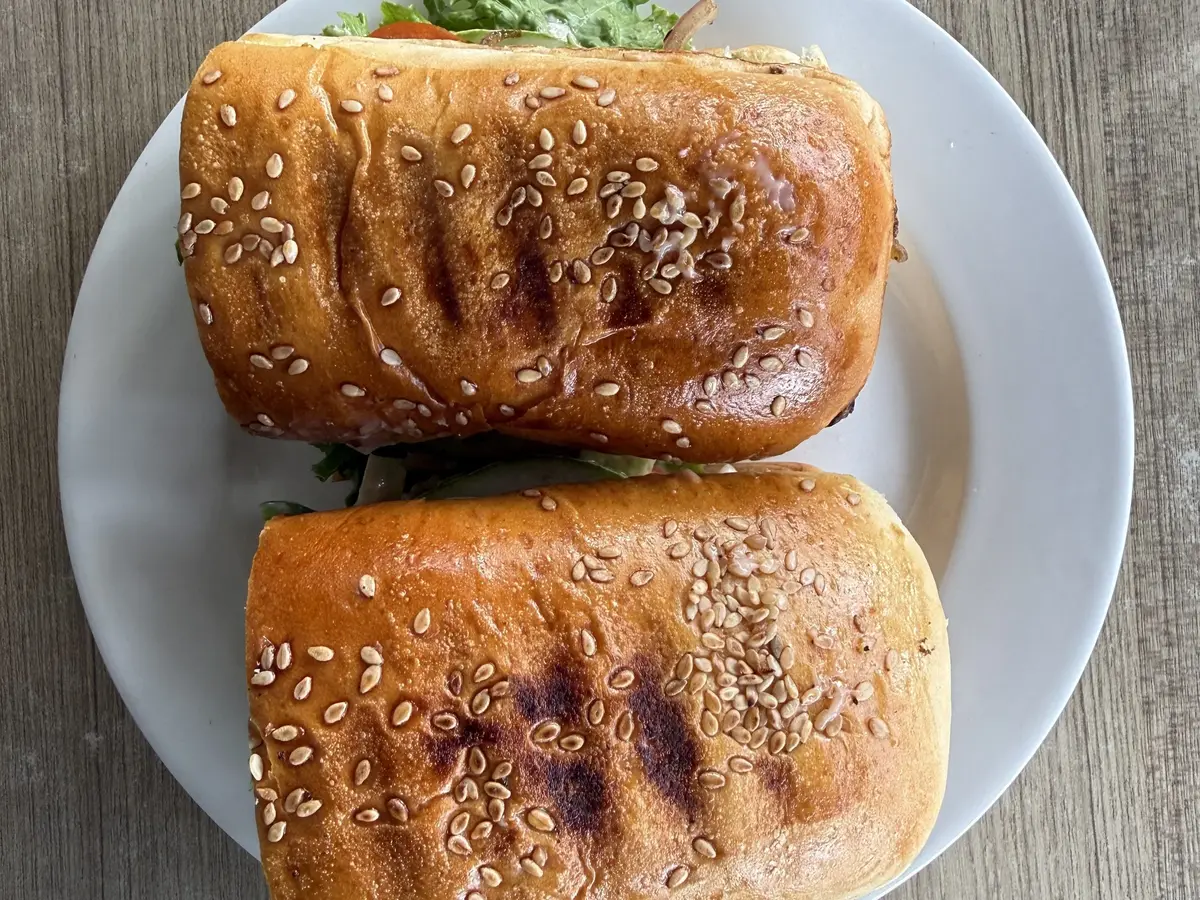 Dos bocadillos de pan con sésamo rellenos de lechuga y tomate