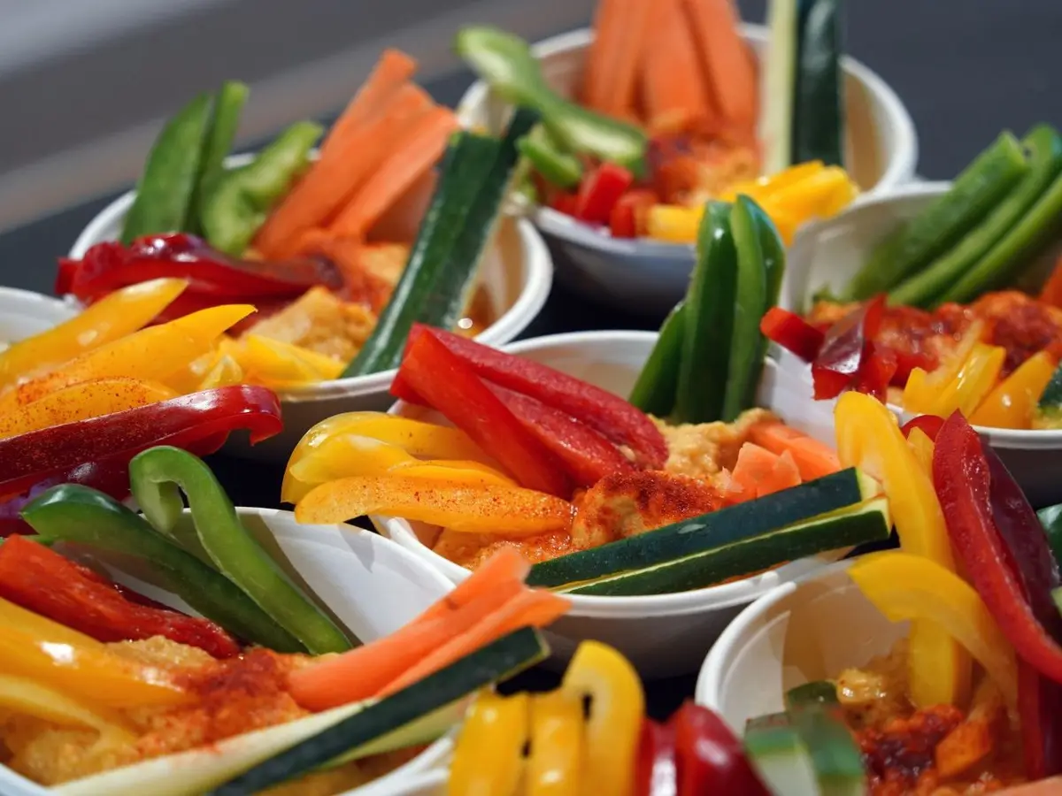 Cuencos de hummus con bastones de zanahoria, pimiento y calabacín