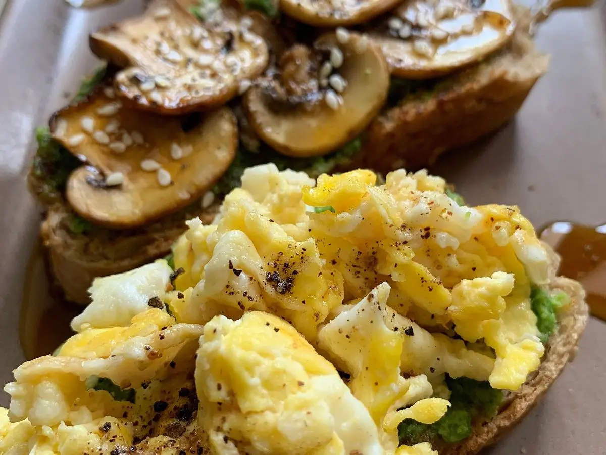 Tostadas con champiñones laminados y huevos revueltos con pimienta